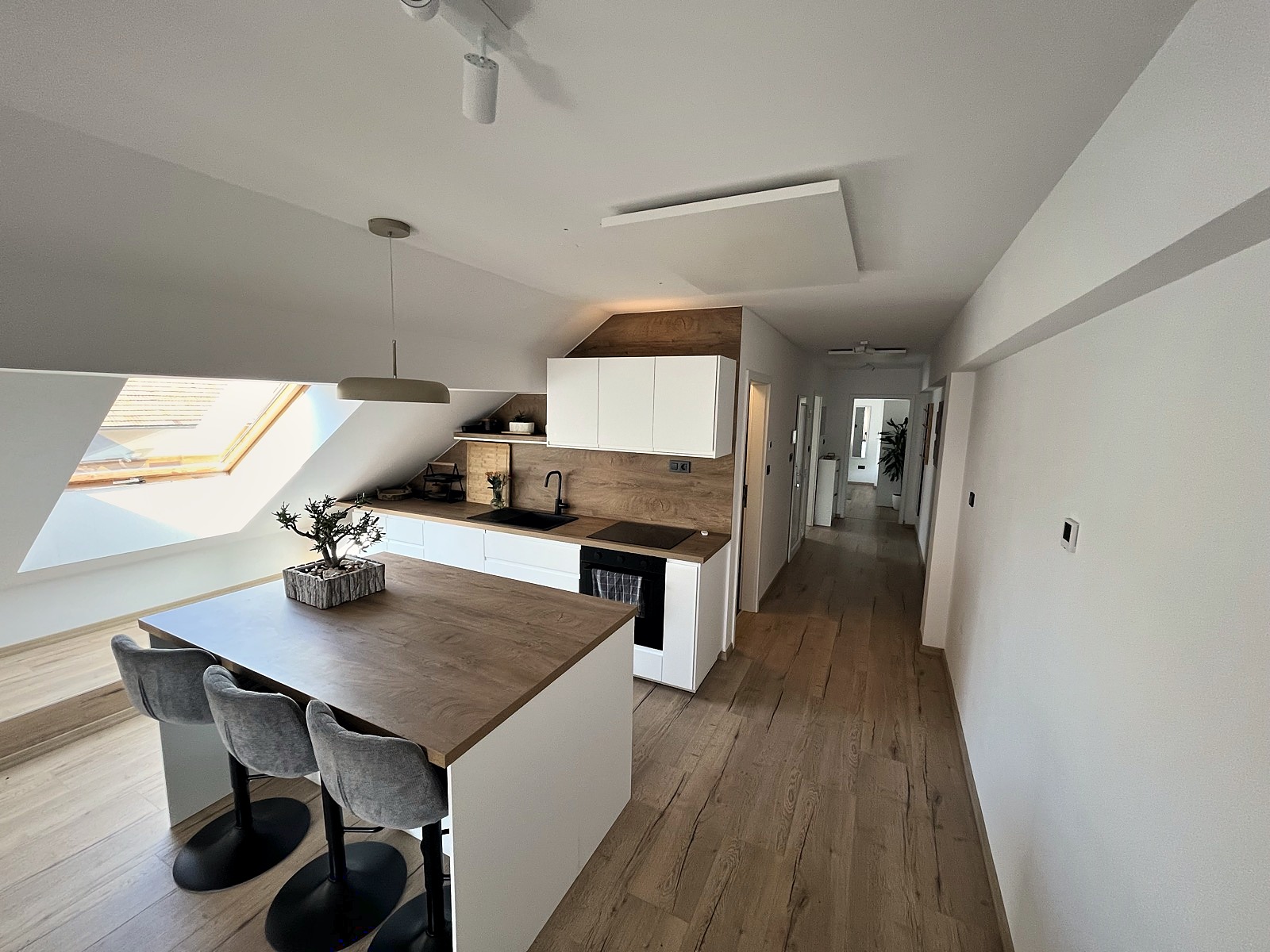 The kitchen island and breakfast bar under the attic skylight